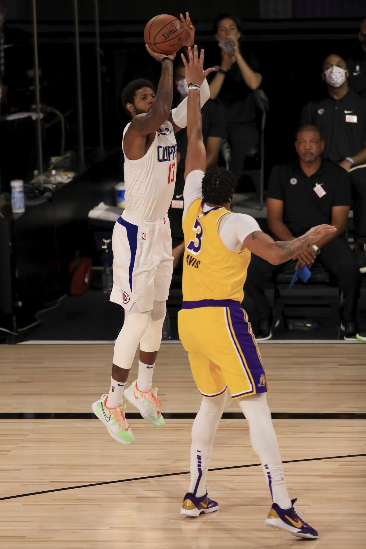 Paul George attempts a shot over Anthony Davis.