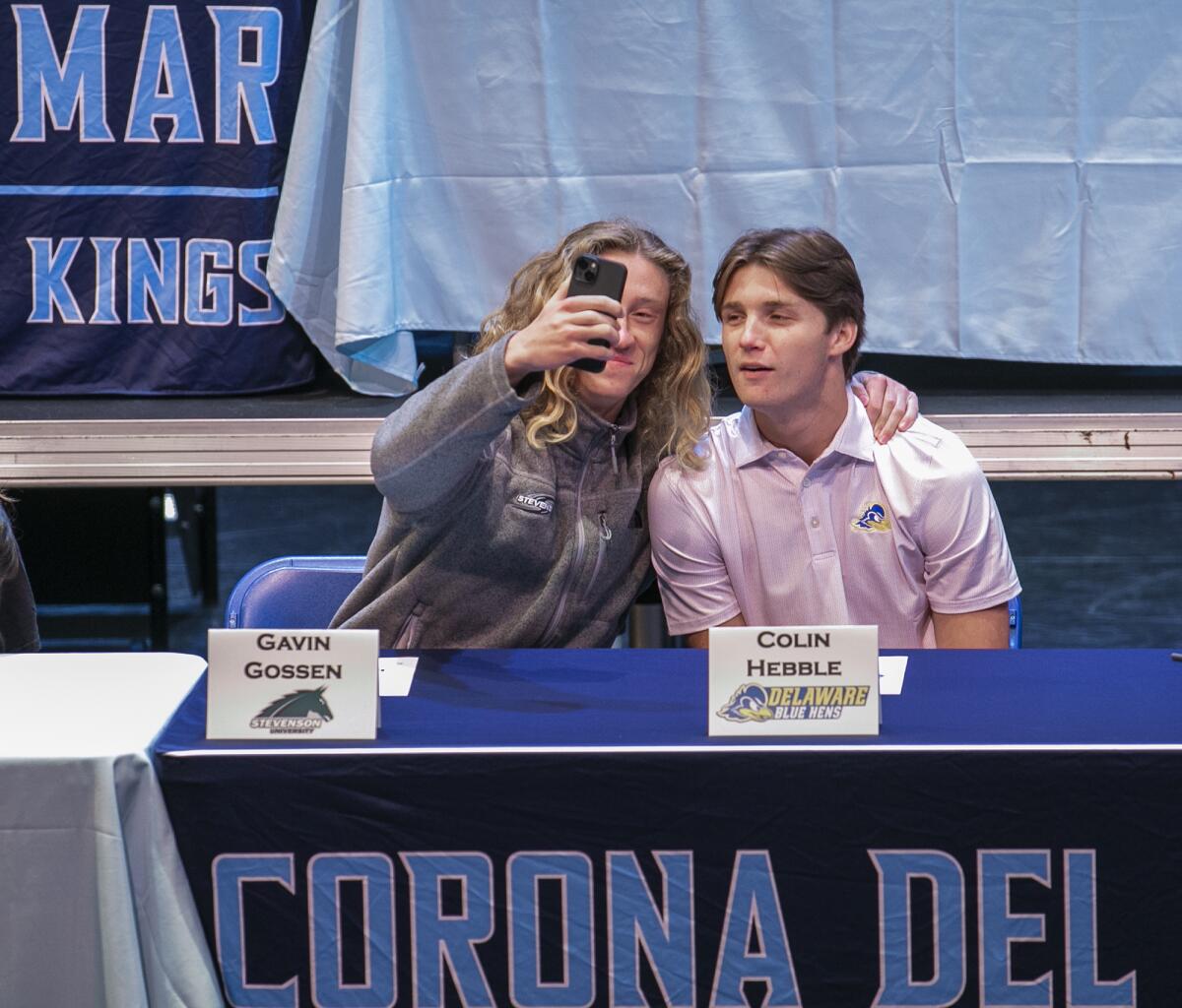 Gavin Gossen, left, and Colin Hebble take a selfie during Corona del Mar High School signing day on Monday.