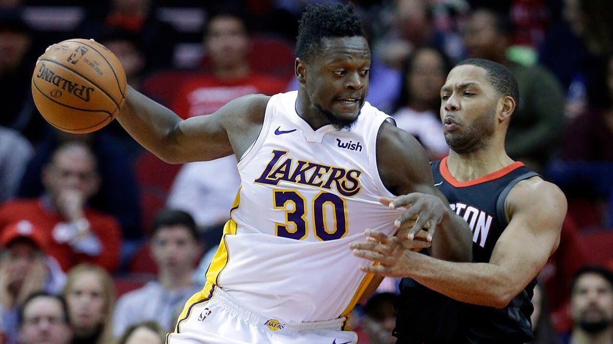 Lakers forward Julius Randle drives into Houston Rockets guard Eric Gordon in the second half Sunday.