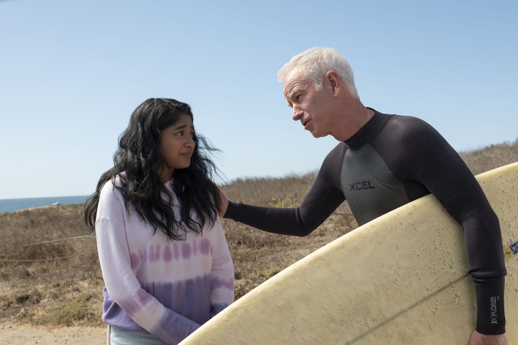 Maitreyi Ramakrishnan as Devi Vishwakumar and John McEnroe in a scene from the Netflix first season of "Never Have I Ever."