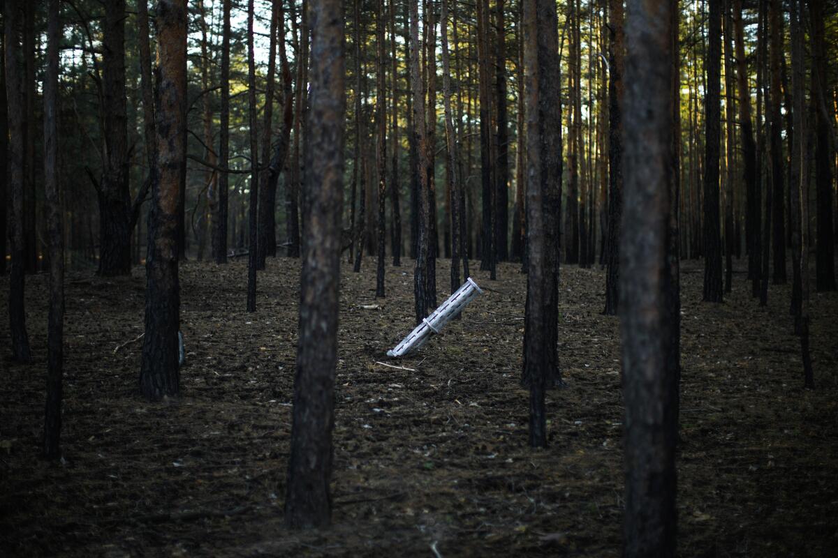 Russian rocket protruding from forest floor