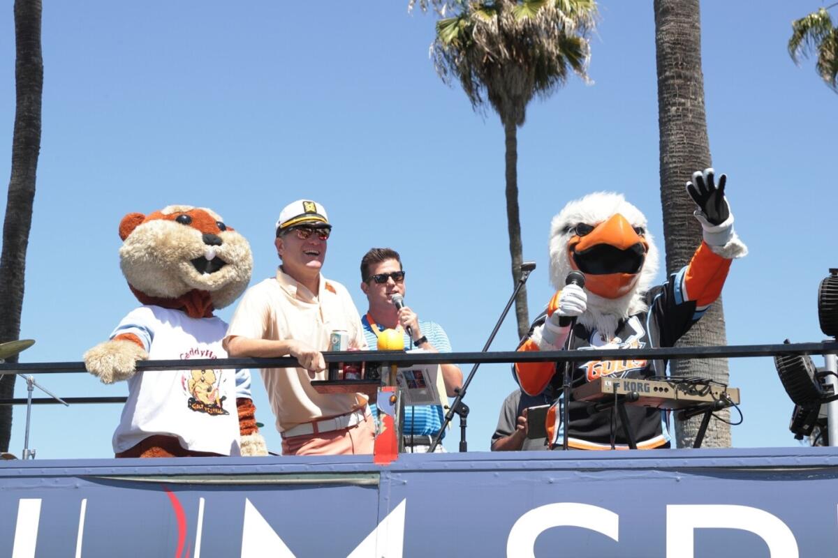 Mascots join event host Ernie Hahn and the auctioneer to welcome players at last year's CaddyHack event.