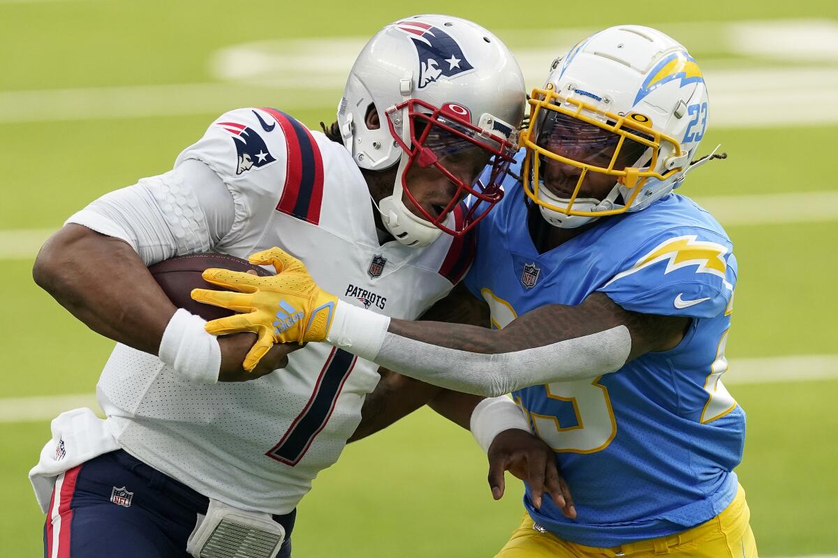 Chargers safety Rayshawn Jenkins tackles New England Patriots quarterback Cam Newton.