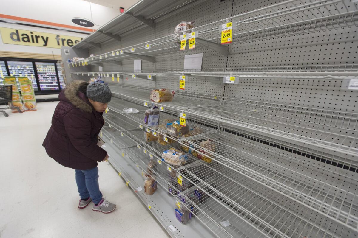 Shelves were mostly empty in this Alexandria, Va., grocery store a day before the storm.