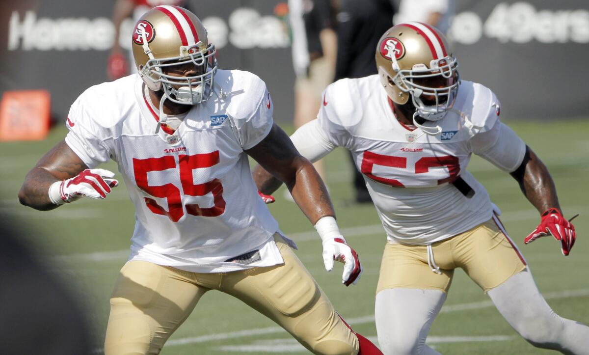 San Francisco 49ers outside linebacker Ahmad Brooks, left, and NaVorro Bowman line up during a training camp practice on Aug. 18.