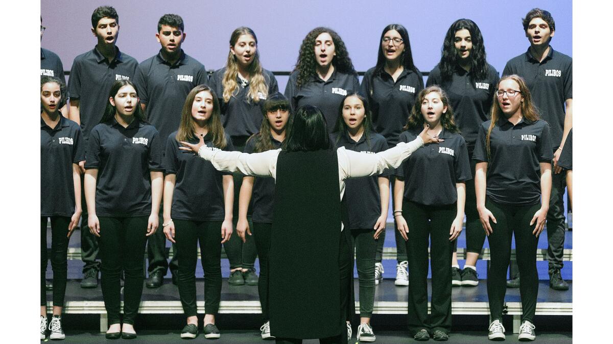 Students from The Rose and Alex Pilibos Armenian School sing the national anthems of the United States and Armenia at the Armenian Genocide commemoration at the Alex Theatre in Glendale on Tuesday, April 24, 2018.