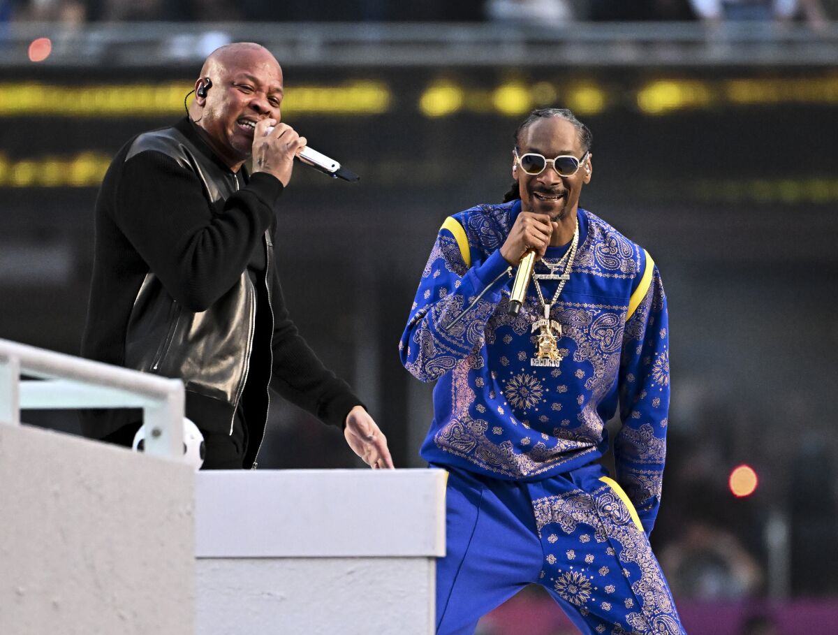 Two men singing into microphones.