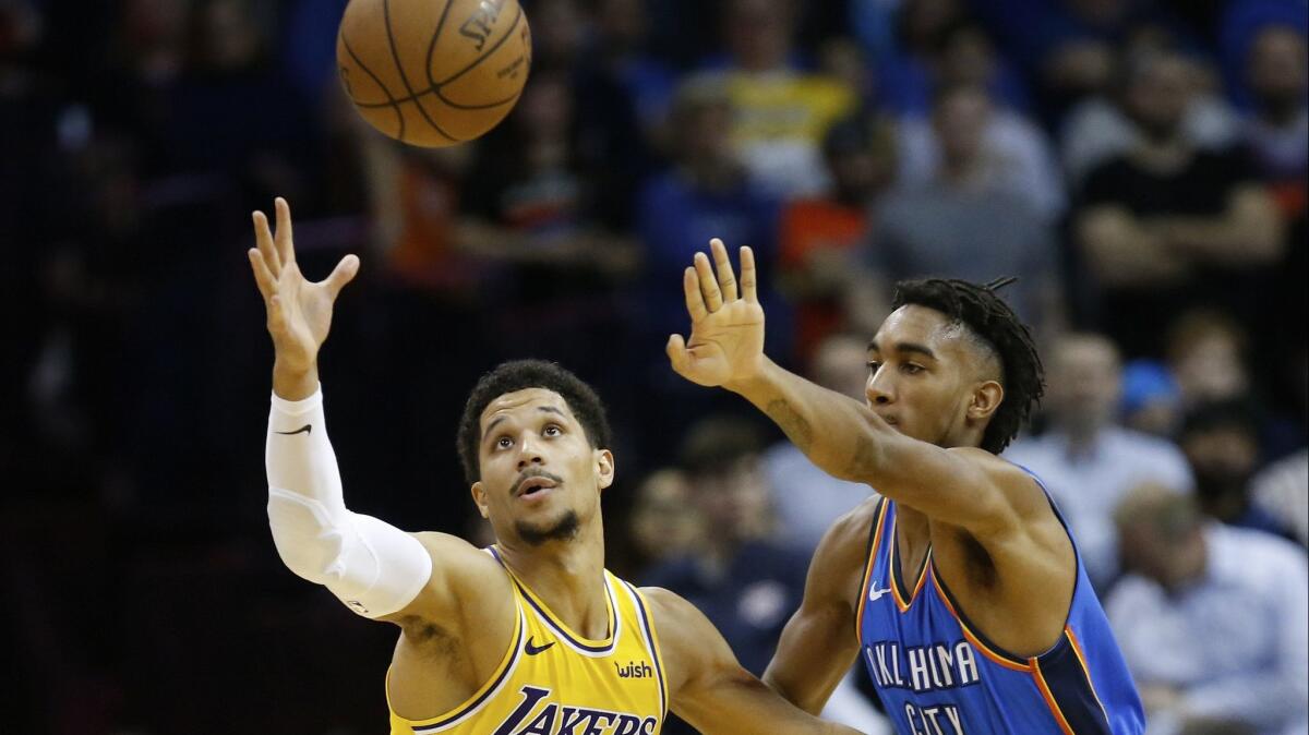 Lakers guard Josh Hart, left, reaches for the ball in front of Oklahoma City's Terrance Ferguson.