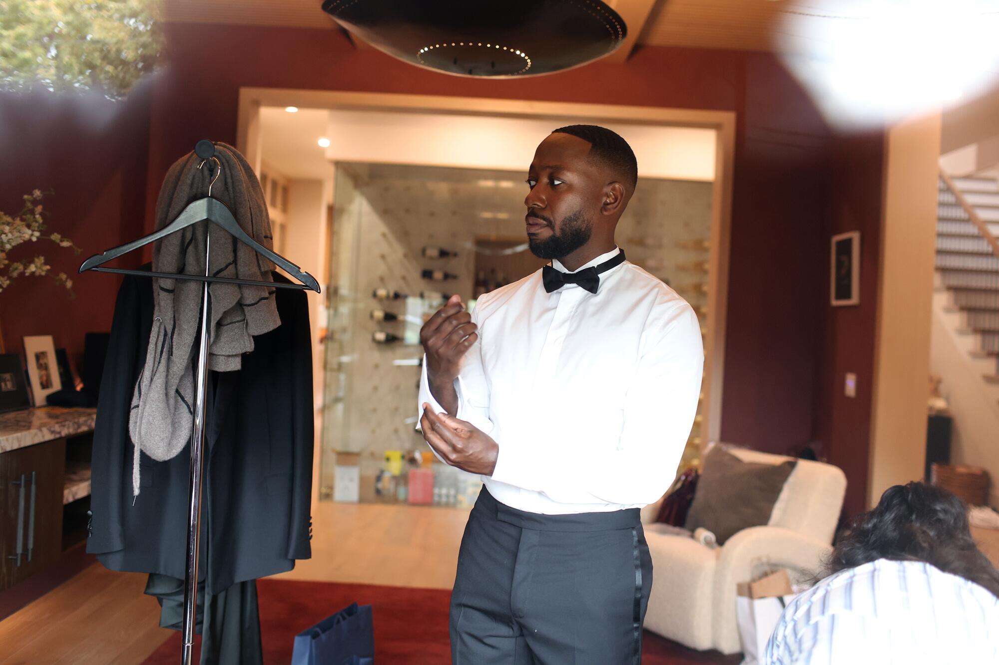 A man in a white shirt and black bow tie.