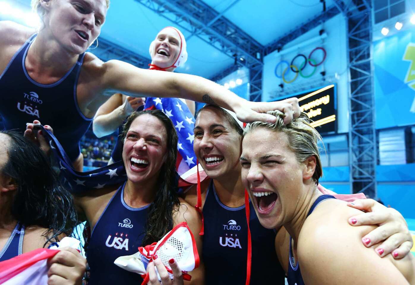 U.S. players celebrate winning the women's water polo gold medal match between the United States and Spain.