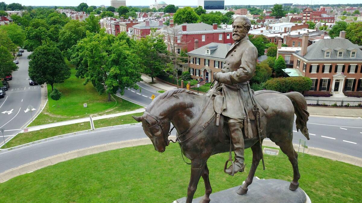 A statue of Confederate Gen. Robert E. Lee stands in the middle of a traffic circle in Richmond, Va.