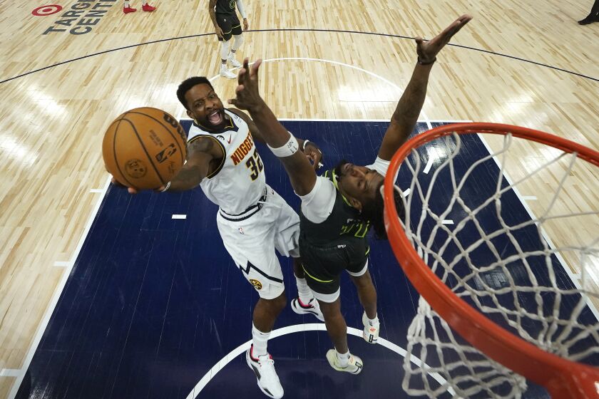 Denver Nuggets forward Jeff Green (32) shoots against Minnesota Timberwolves center Naz Reid (11) during the first half of an NBA basketball game, Sunday, Feb. 5, 2023, in Minneapolis. (AP Photo/Abbie Parr)