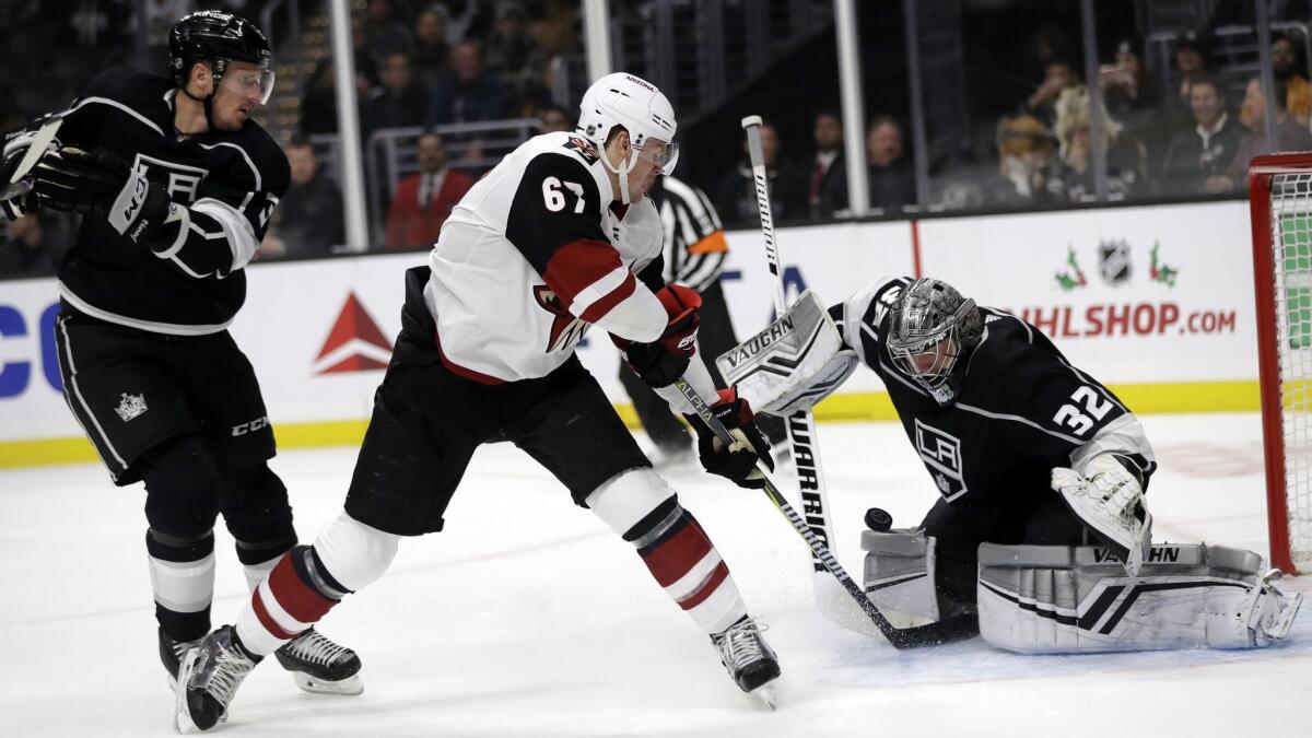 Arizona Coyotes' Lawson Crouse, center, scores past Kings goaltender Jonathan Quick (32) during the first period.