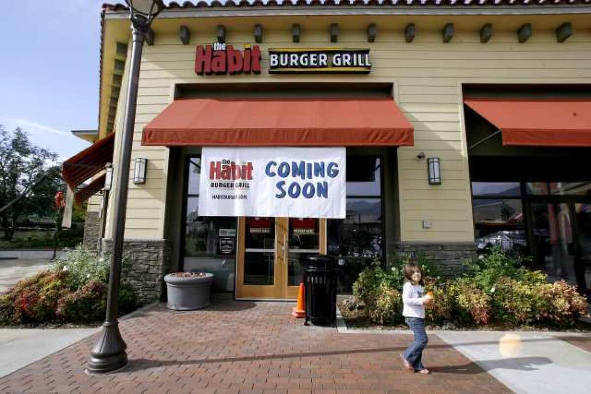 A young girl walks past the soon-to-open Habit Burger Grill at the Town Center in La Canada Flintridge.