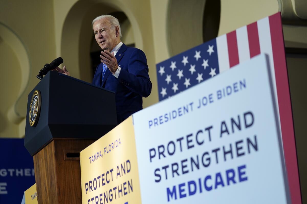 President Biden speaks near a poster about protecting Social Security and Medicare