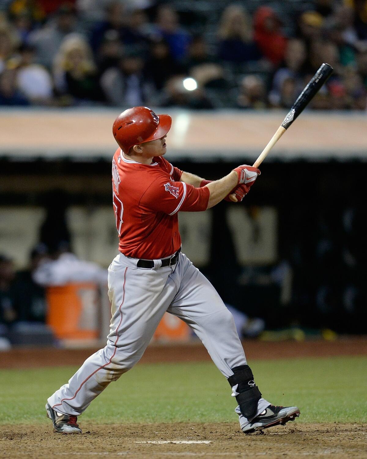 Angels left fielder Mike Trout hits a two-run home run during the team's 12-1 win over the Oakland Athletics.