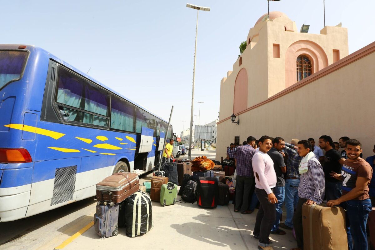 Egyptian workers in Tripoli prepare to evacuate Libya on Thursday. Thousands of foreign diplomats and workers from dozens of countries have fled Libya's deadly chaos in recent days.