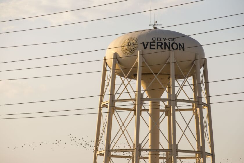 The City of Vernon water tower sits along the Los Angeles River. The 45-unit Vernon Villiage Park Apartments complex that is nearing completion is the first privately-owned residence the city will have in decades.