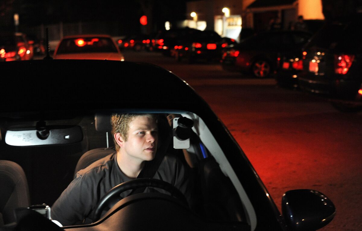 Jimmy Lucia waits to pick up passengers in Hollywood as part of his ride-sharing job at night. A tentative deal on ride-sharing insurance requirements is emerging in the state Legislature.
