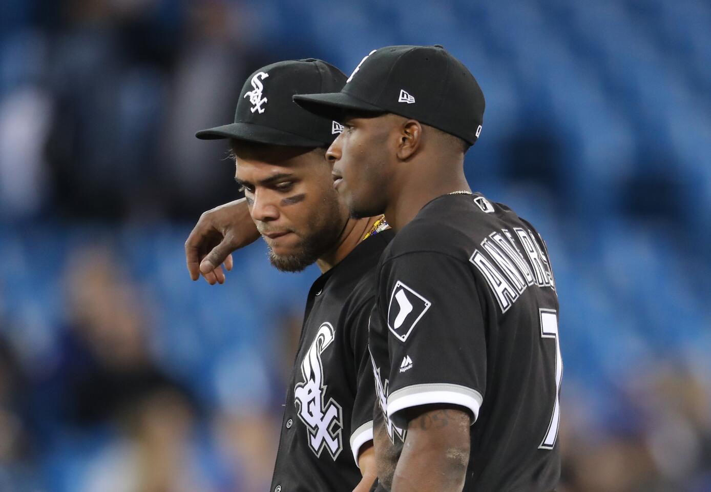 Tim Anderson puts his arm around Yoan Moncada during a pitching change in the eighth inning during MLB game action against the Toronto Blue Jays at Rogers Centre on April 3, 2018 in Toronto, Canada.