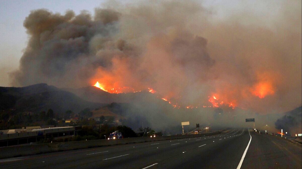 The Woolsey fire burns in the hills off the 101 Freeway at Cheseboro Road in Agoura Hills on Nov. 9.