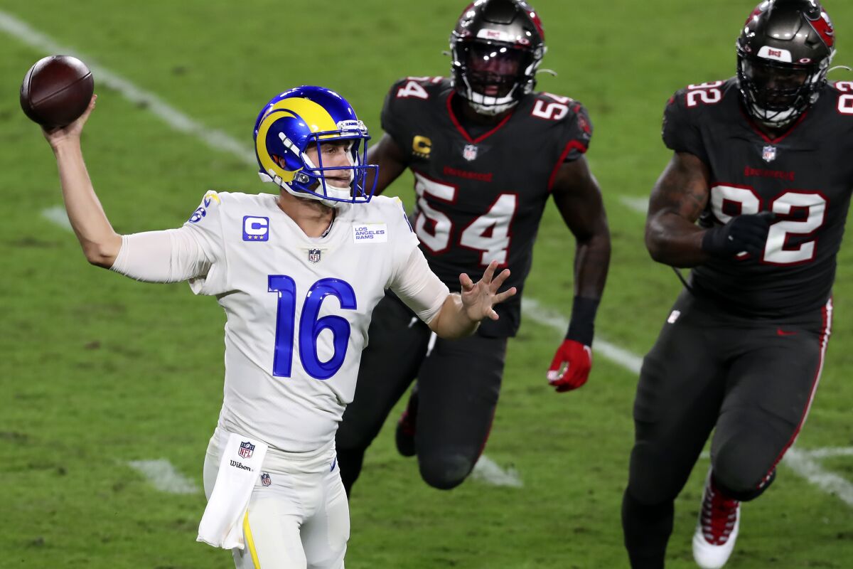 Rams quarterback Jared Goff throws a pass under pressure from Tampa Bay's Lavonte David and William Gholston.