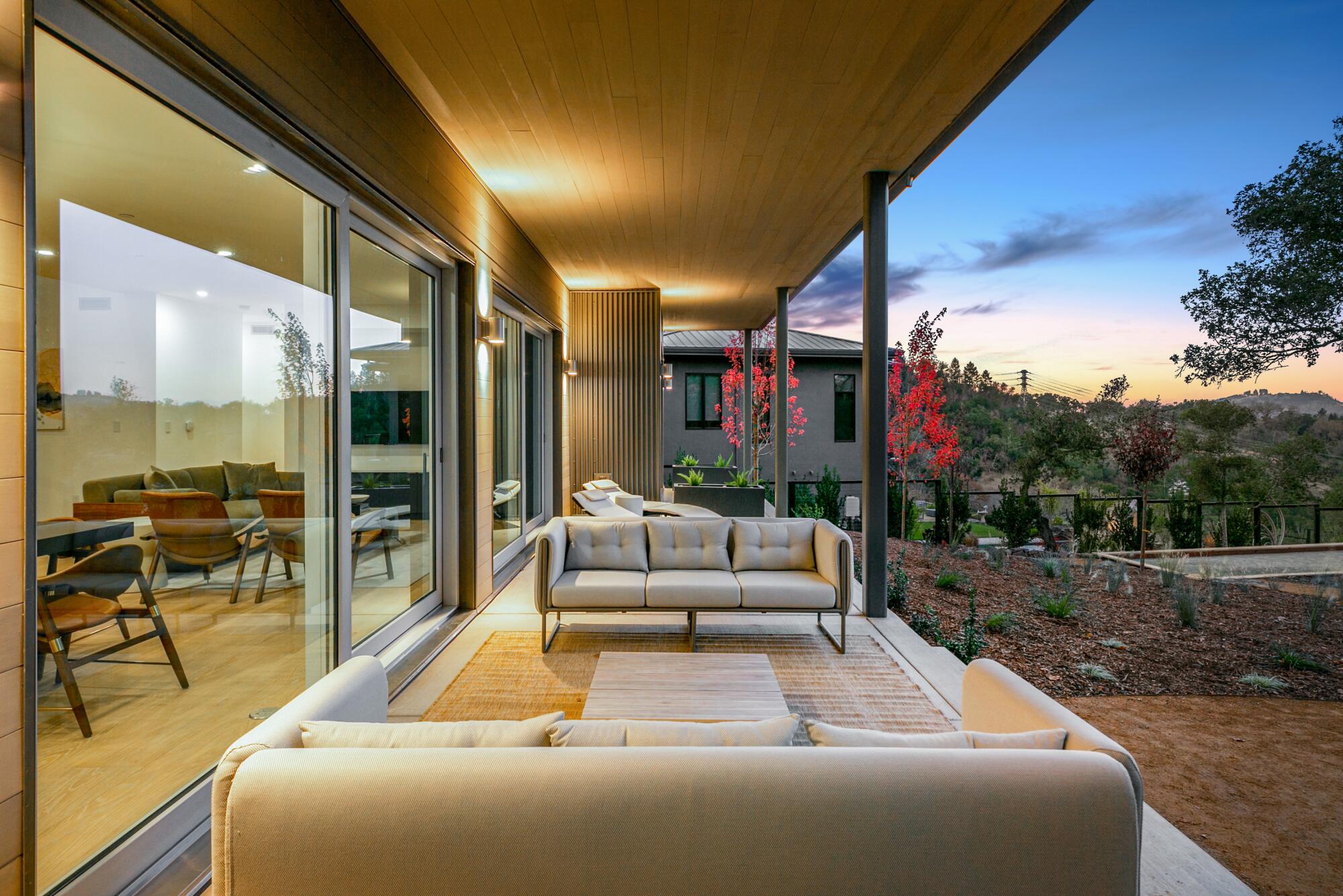 The glass-lined back porch of a Dvele house constructed with modules made in a factory.
