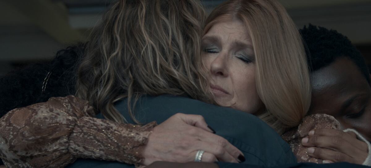 Two women embrace in grief
