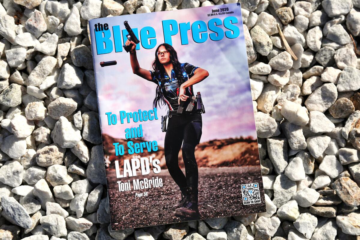 LAPD Officer Toni McBride raises a gun on the cover of June's Blue Press magazine, popular with police and firearms fans.