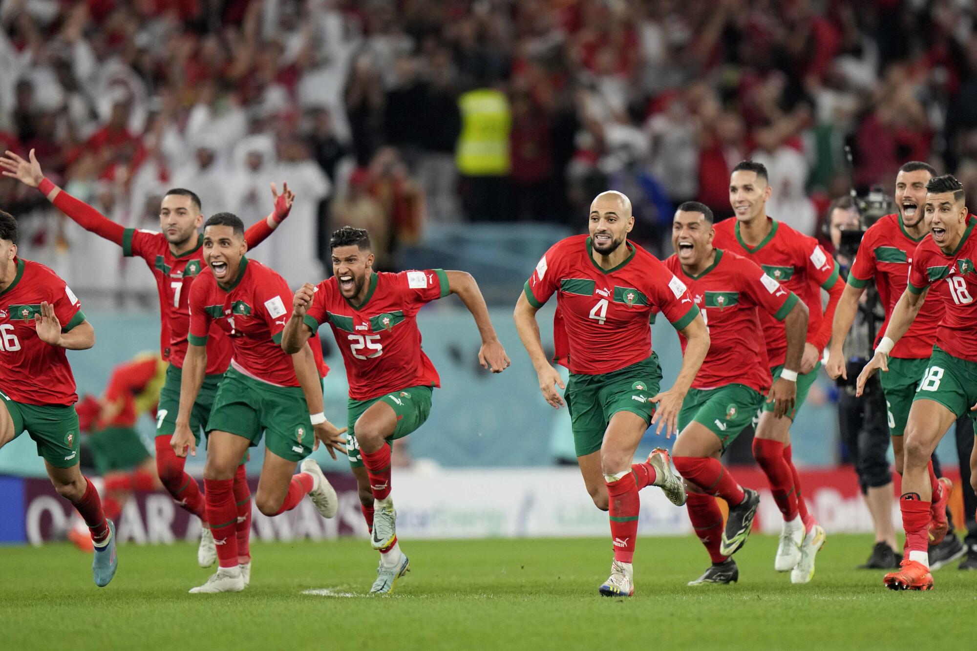 Morocco's players celebrate after the penalty shootout at the World Cup.