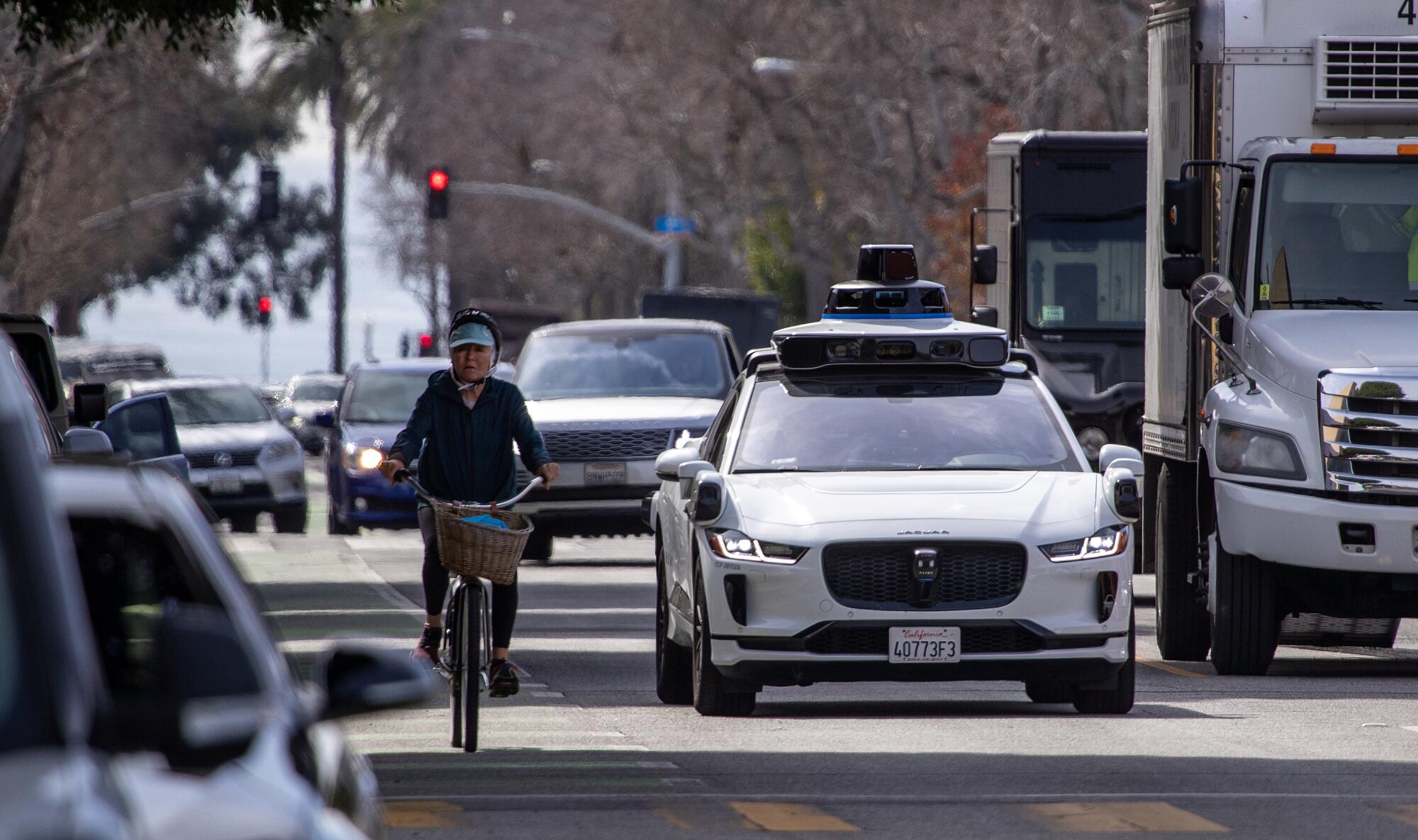 An electric Jaguar I-Pace car outfitted with Waymo full self-driving technology drives through Santa Monica on Feb. 21.