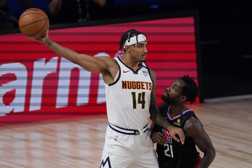 Denver Nuggets' Gary Harris (14) keeps the ball from Los Angeles Clippers' Patrick Beverley (21) in the second half of an NBA conference semifinal playoff basketball game Thursday, Sept 3, 2020, in Lake Buena Vista Fla. (AP Photo/Mark J. Terrill)