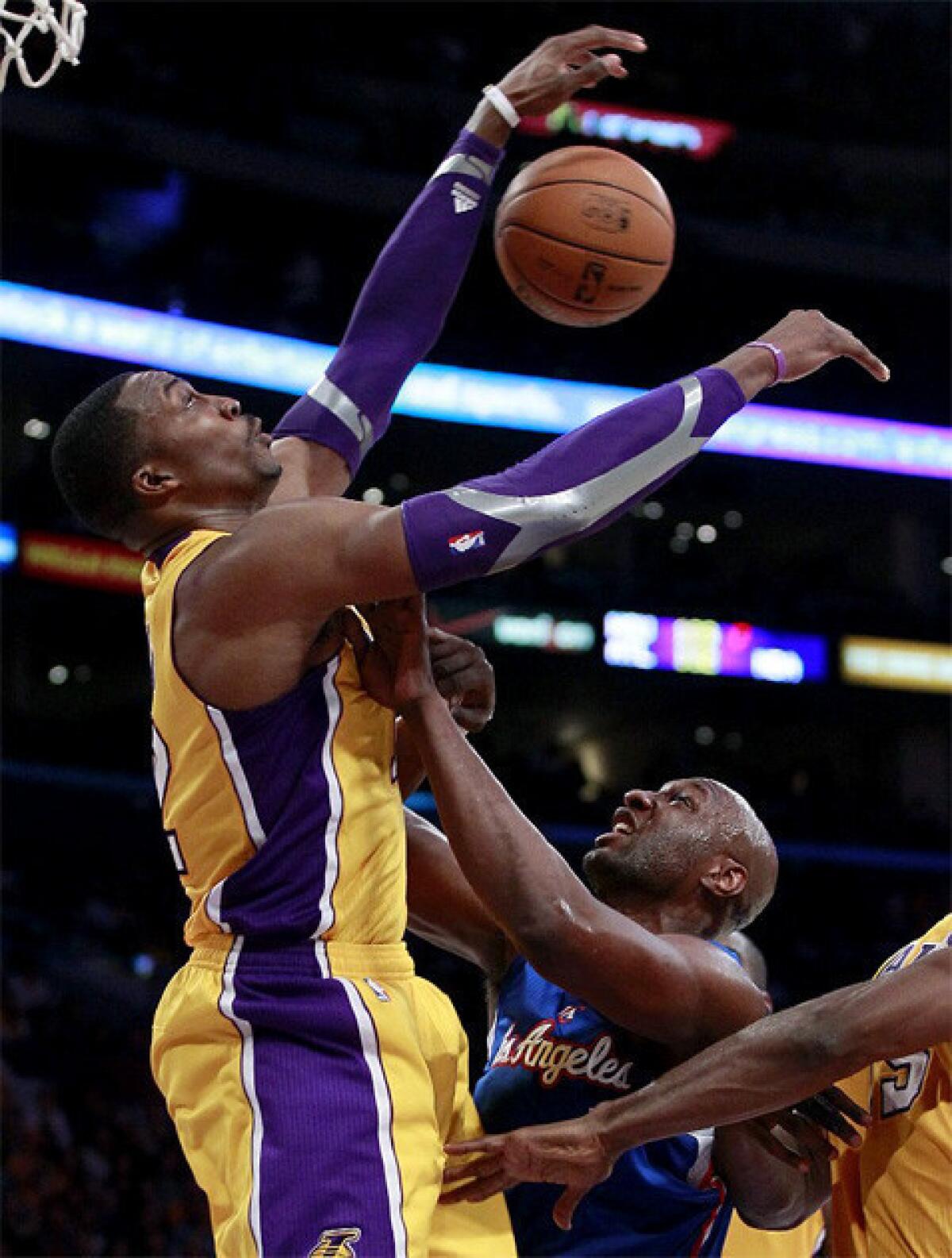 The Lakers' Dwight Howard blocks Lamar Odom's shot in the second half of Friday's game against the Clippers at Staples Center.