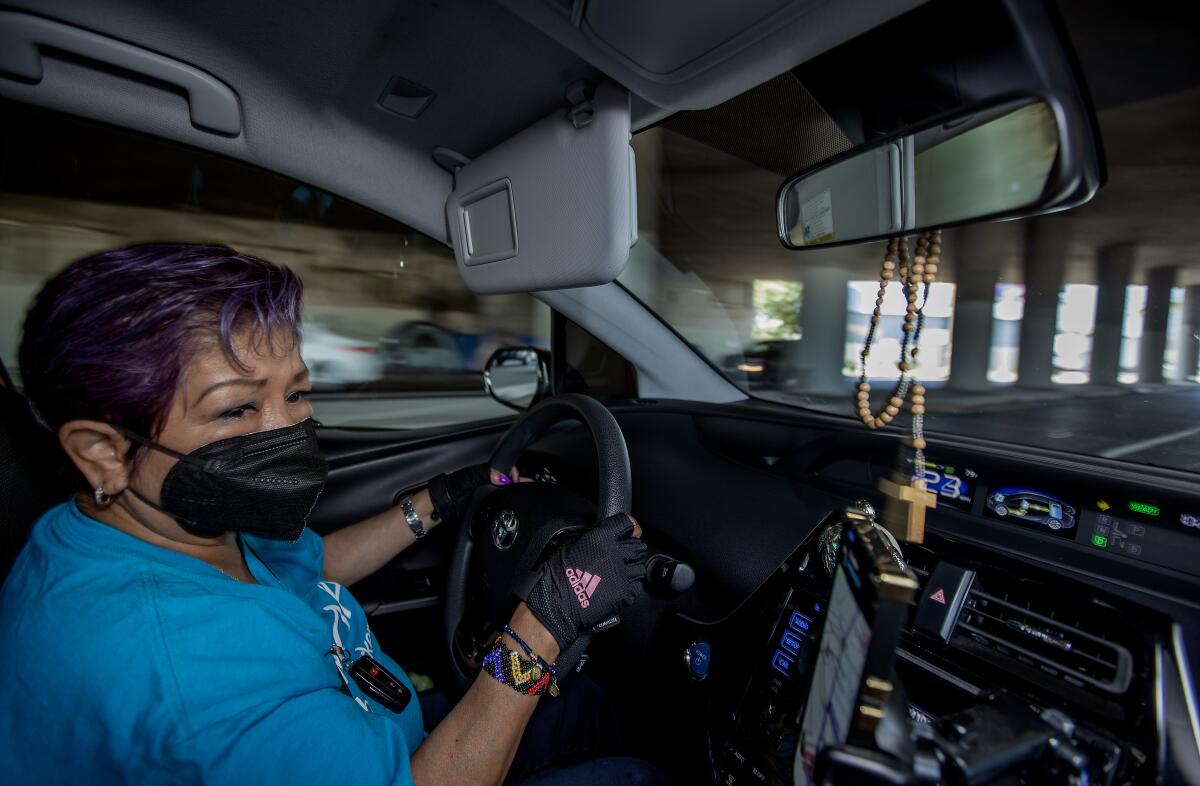 Reyna Hernandez, a Mexican immigrant who drives for Uber and Lyft, drive a customer to their destination. 