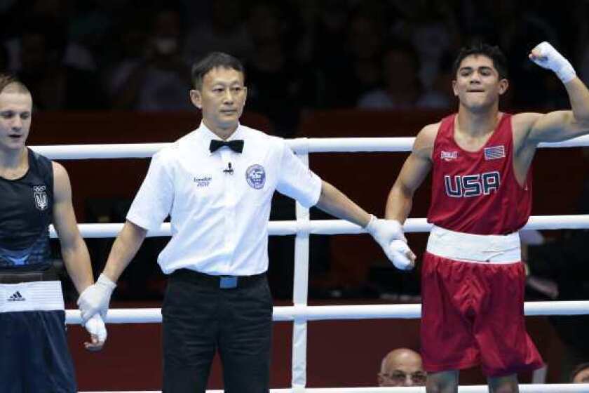 Joseph Diaz Jr., right, is declared the winner of the opening match of the Olympic boxing competition after dominating Ukraine's Pavlo Ishchenko.