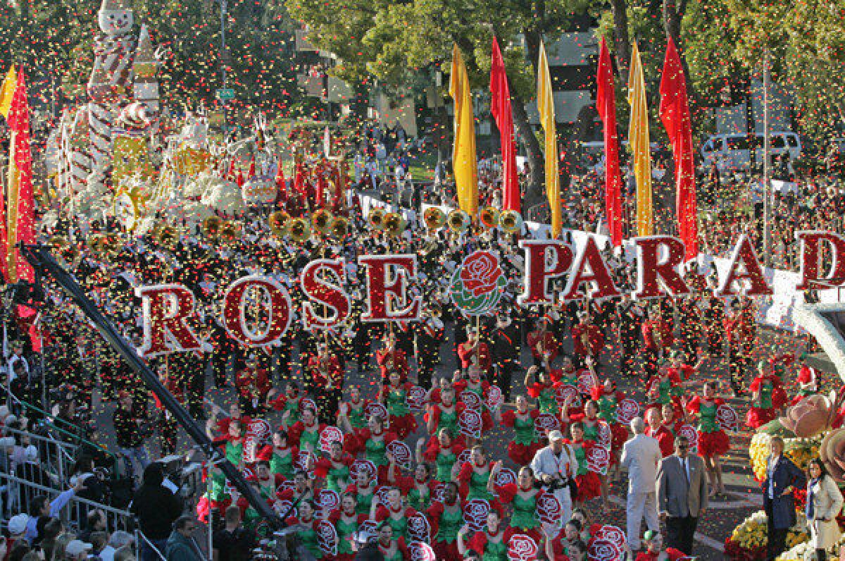 Members of Wells Fargo theme float "Just Imagine..." moves along Orange Grove Boulevard during the 123rd Tournament of Roses Parade in Pasadena.