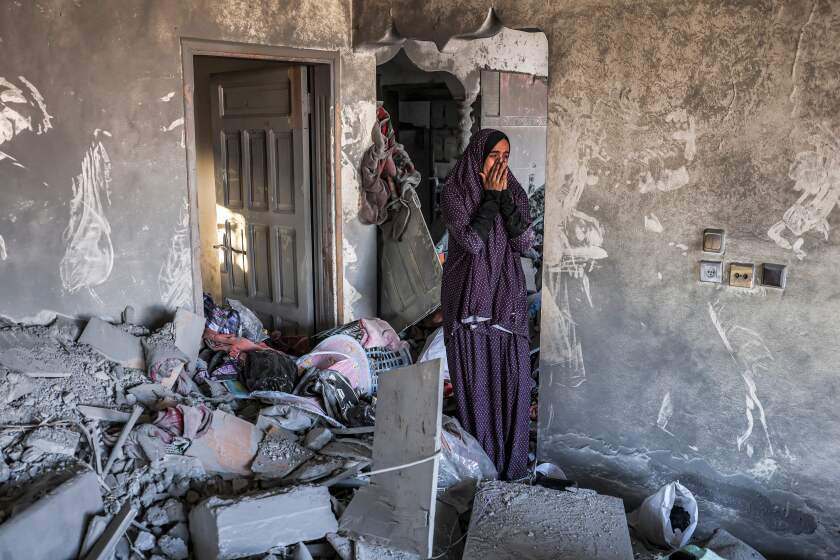 A woman reacts as she stands in a heavily damaged house following Israeli bombardment in Rafah in the southern of Gaza Strip on October 19, 2023. Thousands of people, both Israeli and Palestinians have died since October 7, 2023, after Palestinian Hamas militants based in the Gaza Strip, entered southern Israel in a surprise attack leading Israel to declare war on Hamas in Gaza on October 8. (Photo by Mohammed ABED / AFP) (Photo by MOHAMMED ABED/AFP via Getty Images)