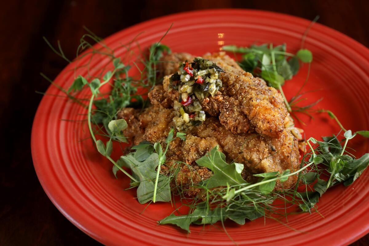 Post & Beam's jerked catfish, served with a spicy, bright herb sauce, over a bed of dirty rice