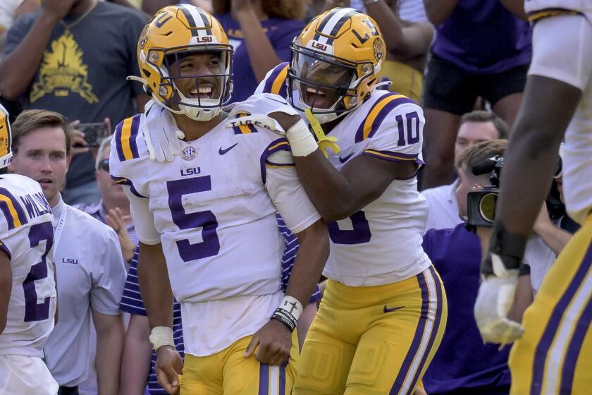 LSU quarterback Jayden Daniels (5) celebrates his touchdown with LSU wide receiver Jaray Jenkins (10) during the second half of an NCAA college football game against Mississippi in Baton Rouge, La., Saturday, Oct. 22, 2022. (AP Photo/Matthew Hinton)
