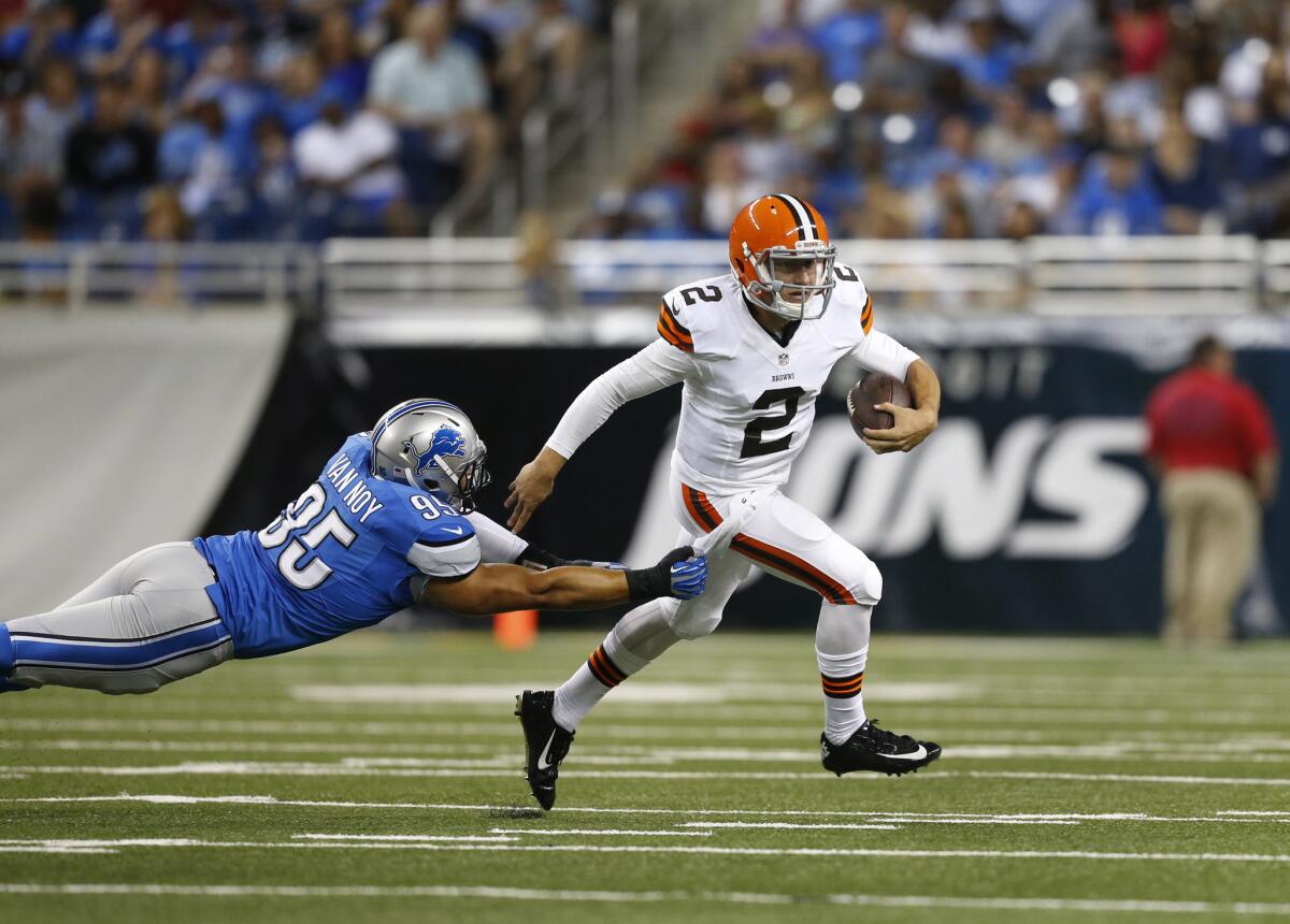 Browns quarterback Johnny Manziel escapes the grasp of Lions linebacker Kyle Van Noy during a scramble in a preseason game Saturday night in Detroit.