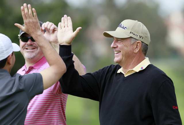 Jay Haas, right, and Julian Gangolli, center, high five Michael Jafar after he made a putt during the pro-am at the Toshiba Classic on Thursday.