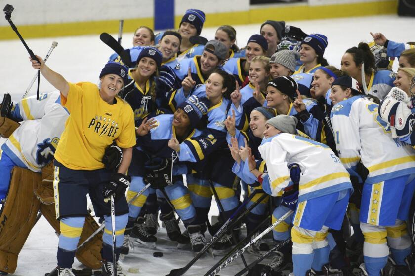 FILE - In this Jan. 24, 2016, file photo, National Women's Hockey League All-Star players take time for a "selfie" before the start of an all-star game at Harborcenter in Buffalo, N.Y. NWHL founder and commissioner Dani Rylan tells The Associated Press she considers the likelihood of North America having one women's professional hockey league as being "inevitable." Rylans comments, made in an email to The AP, are considered her strongest regarding a potential merger with the rival Canadian Womens Hockey League since the NWHL was formed three years ago. (AP Photo/Gary Wiepert, File)
