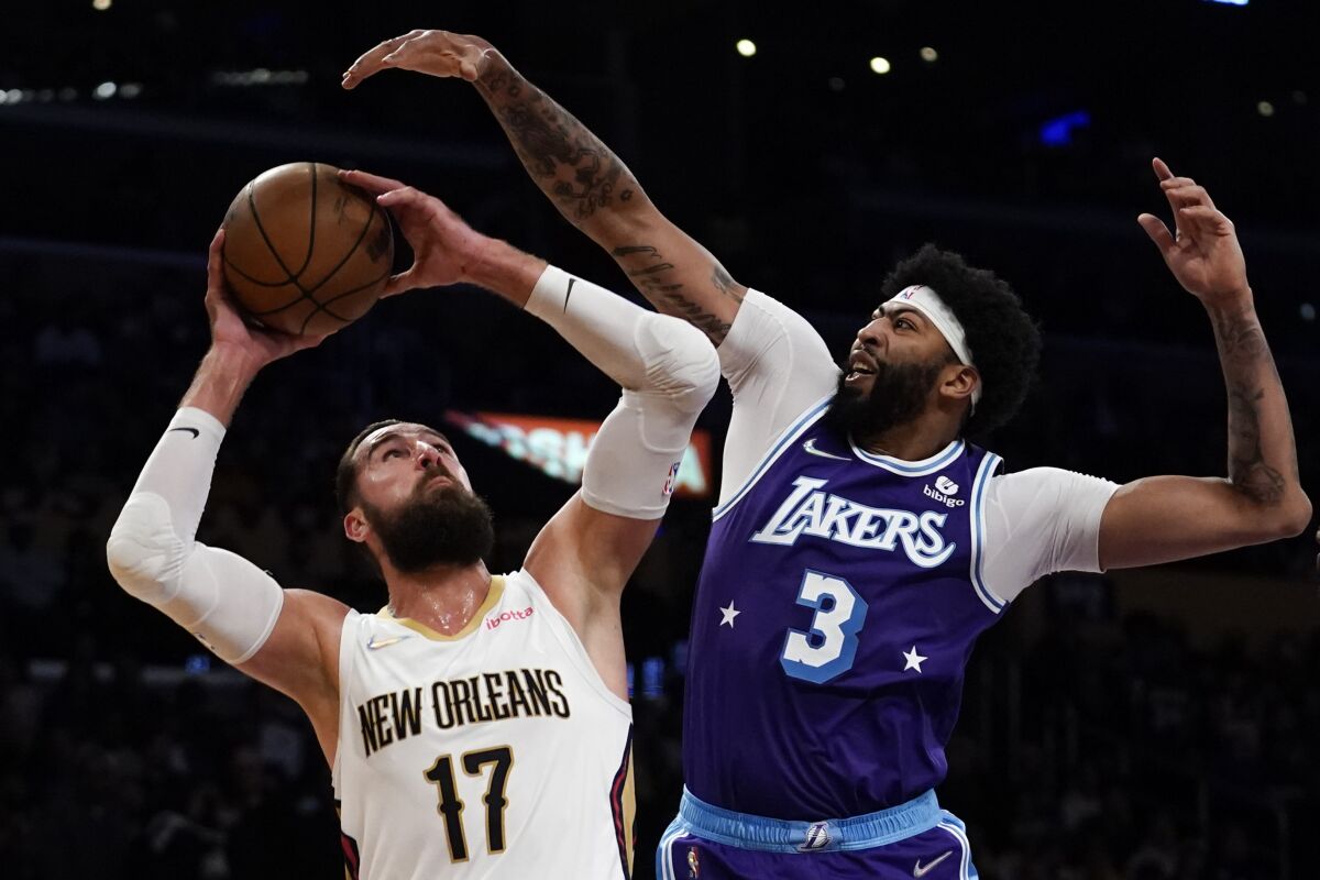 Los Angeles Lakers forward Anthony Davis (3) defends against New Orleans Pelicans center Jonas Valanciunas (17) during the first half of an NBA basketball game in Los Angeles, Friday, April 1, 2022. (AP Photo/Ashley Landis)