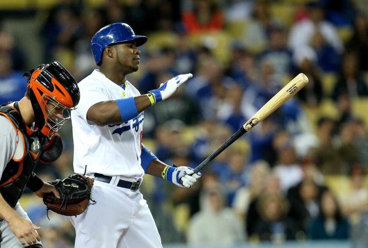 Dodgers right fielder Yasiel Puig reacts after striking out with a runner on second base to end the eighth inning in a game against the Giants on Thursday night.