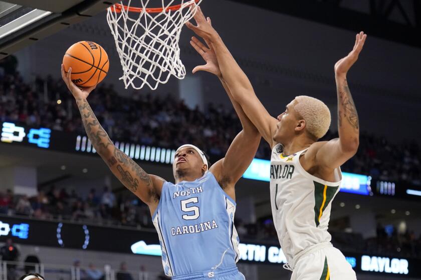 North Carolina forward Armando Bacot (5) goes up for a shot as Baylor forward Jeremy Sochan (1) defends in the first half of a second-round game in the NCAA college basketball tournament in Fort Worth, Texas, Saturday, March, 19, 2022. (AP Photo/Tony Gutierrez)