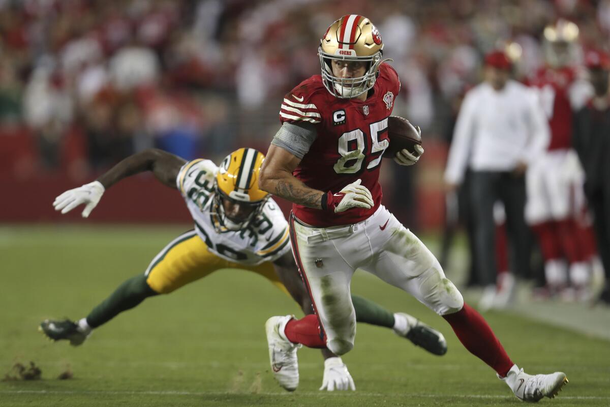 San Francisco 49ers tight end George Kittle (85) runs in front of Green Bay Packers defensive back Chandon Sullivan (39) during the second half of an NFL football game in Santa Clara, Calif., Sunday, Sept. 26, 2021. (AP Photo/Jed Jacobsohn)