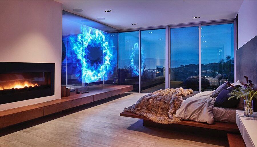 The bedroom has views of the outdoors and furniture.