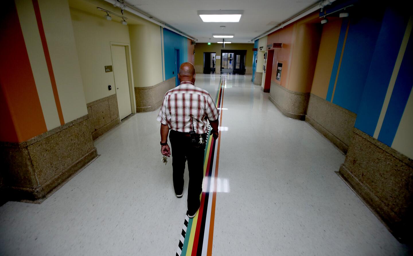 A man walks down a hallway in the Los Angeles County General Hospital.