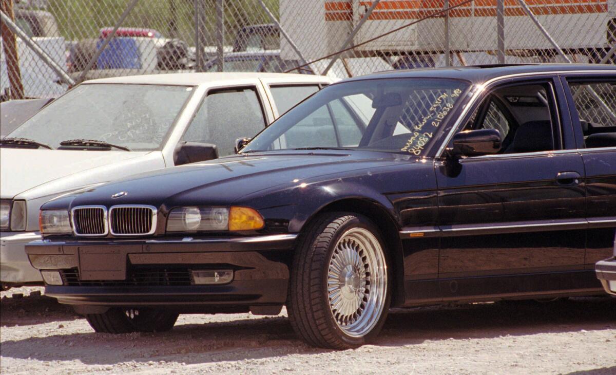 A black BMW, riddled with bullet holes, is seen in a Las Vegas police impound lot. Rapper Tupac Shakur was shot 