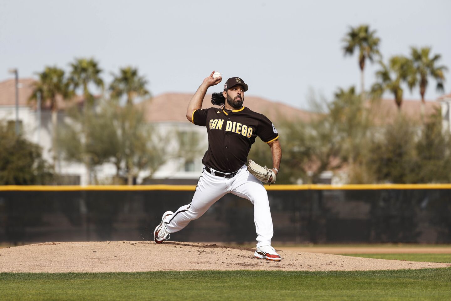 Padres relief pitcher Nabil Crismatt (74) tosses a pitch during a spring training practice at Peoria Sports Complex on Friday.
